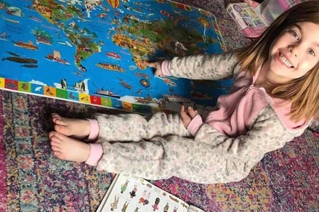 Linda Louise Marshall said: "Matilda aged 7 1/2 doing some geography in a onesie."