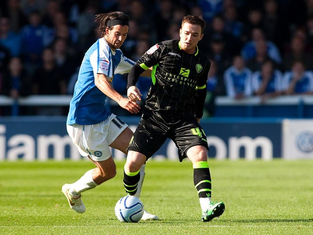 Ross McCormack holds off the challenge of Peterborough's George Boyd during the Championship clash at London Road in October 2011.