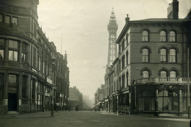 This photo shows Market Street From Talbot Square. The Clifton Hotel is on the right and beyond the cyclist (with what appears to be a plank across his back ) there is a stall on the corner of the old St John's Market