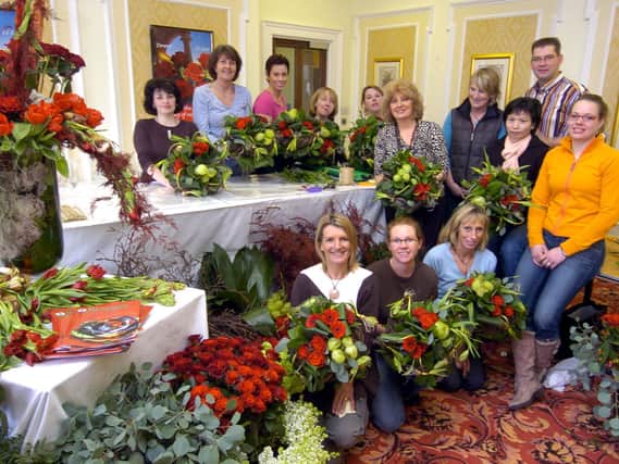 Dutch florists Bert Kuiper (L) and Dini Holtrop share their flower arranging skills at a workshop at the Crown Hotel, co-organised by Scarborough florist Jo Purdy (right), of Hearts and Flowers.