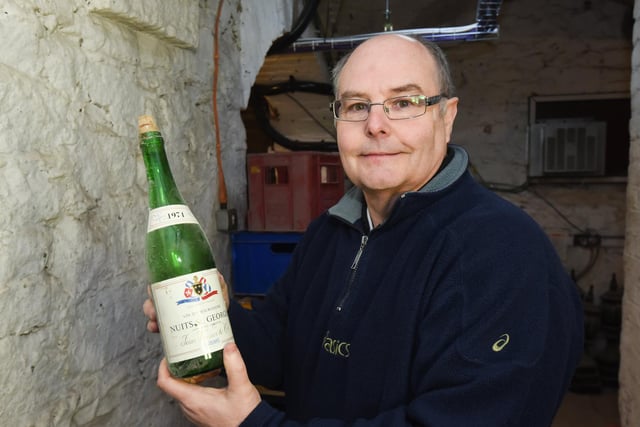 Stephen Dale with an old bottle found in the cellar. It dates back to 1974 and was a French Nuits St Georges wine