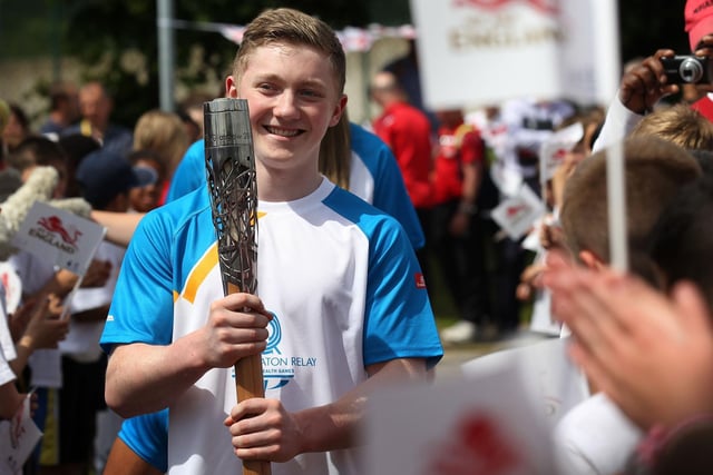 Nile Wilson holds the Queen's Baton at the John Charles Centre for Sport in June 2014.