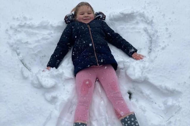 Sarah Wilby's little girl had a look of determination as she worked on her snow angel.