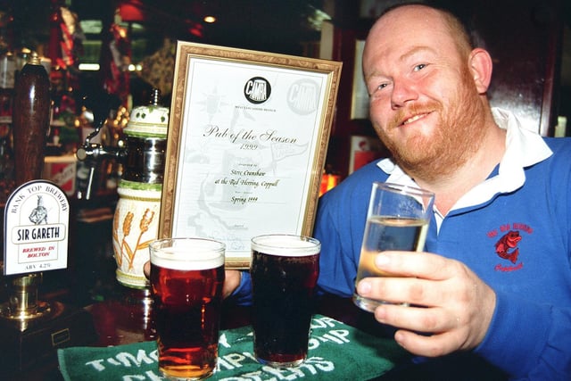 Landlord of The Red Herring, Coppull, near Chorley, Steve Cranshaw, celebrates winning the CAMRA pub of the season award, with a glass of sparkling water.