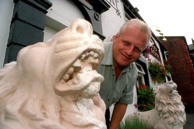 Roaring trade Eddie Newton the landlord of the Red Lion pub in Mawdesley near Chorley with the two stone Lions which guard the entrance to the pub.