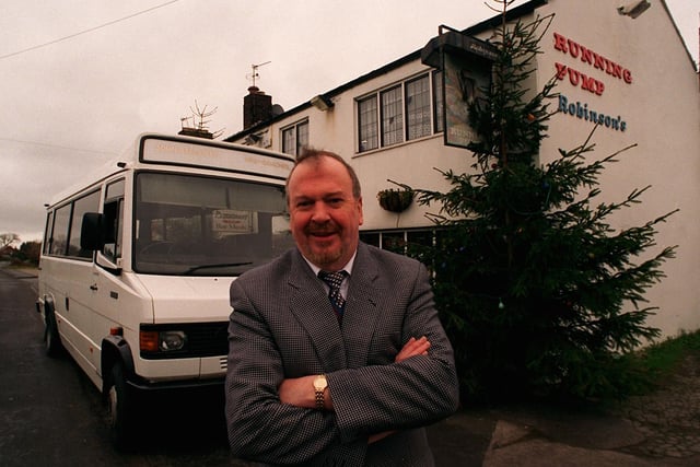 John Egan, Landlord of the Running Pump pub at Catforth near Preston, with the minibus which is used as a free taxi service