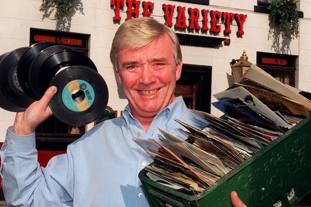 Landlord of The Variety , Adelphi Street, Preston, Terry Hyams, with just a few of the hundreds of singles he has to give to a charity now that the pub has fitted a new CD box