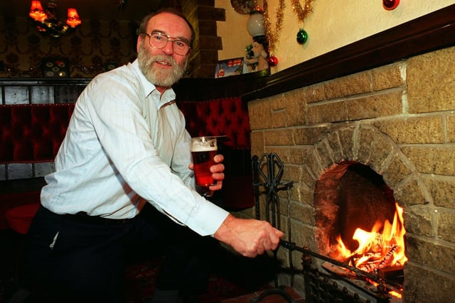 Roger Durrant, landlord of the Royal Oak, Chorley Old Road, Whittle-le-Woods near Chorley, stokes the fire in the cosy lounge of his pub which has just been named CAMRA winter pub of the year.