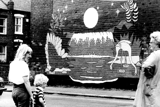 Neighbours look at the blaze of colour which bursts from a row of houses on Cow Close Road in August 1982. The mural was next to the New Blackpool Centre of the Red Ladder Theatre Co.