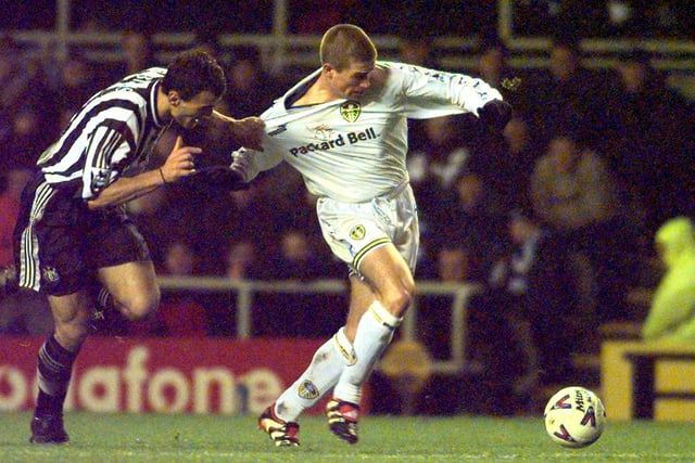 Aaron Hughes tugs on Harry Kewell as he passes over for Lee Bowyer to score.