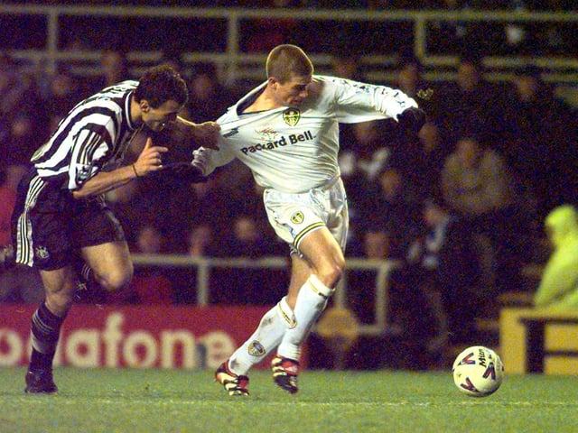 Aaron Hughes tugs on Harry Kewell as he passes over for Lee Bowyer to score.