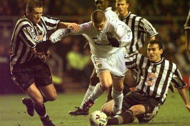 Harry Kewell fights past Newcastle United's Steve Howey and Nikolaos Dabizas.