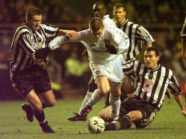 Harry Kewell fights past Newcastle United's Steve Howey and Nikolaos Dabizas.