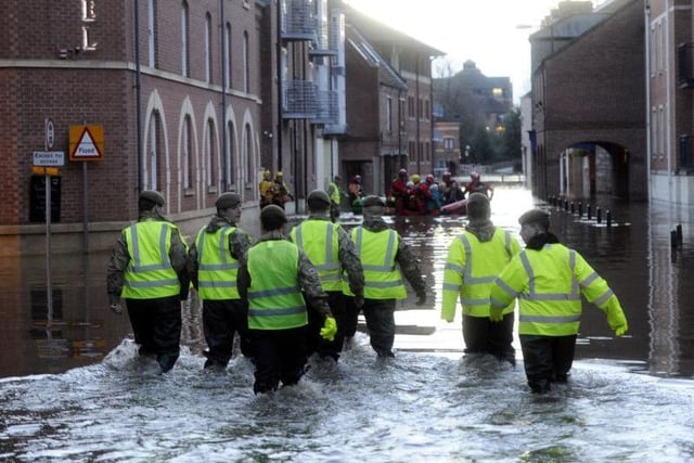 Members of the Army and rescue teams help evacuate people from flooded properties after they became trapped by rising floodwater when the River Ouse bursts its banks in York city centre on Boxing Day 2015.