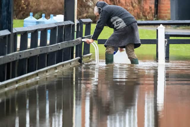 A man in flood water near Naburn Lock Caravan Park in York as Storm Christoph is set to bring widespread flooding, gales and snow to parts of the UK.  Photo: PA