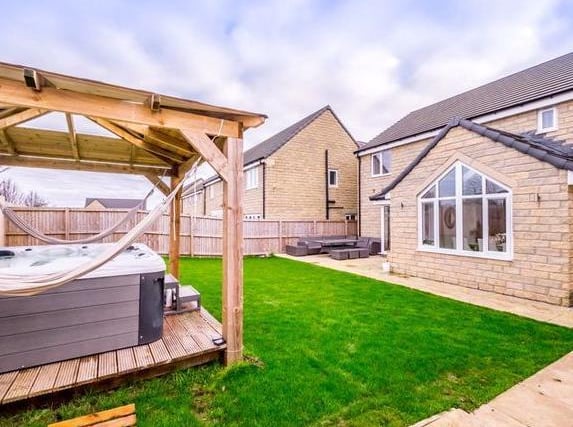 This five bedroom detached home in Shelf features an enclosed rear garden with an extensive lawn and paved patio areas, wood gazebo with decked area underneath ideal for a hot tub. On the market with SW Property - 01422 476819.