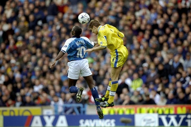 Jonny Woodgate wins an aerial battle with Manchester City's Shaun Goater.