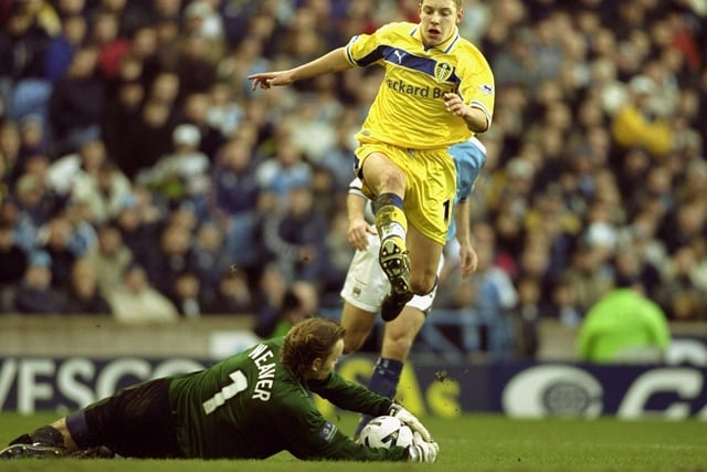 Manchester City goalkeeper Nicky Weaver saves at the feet of Alan Smith.