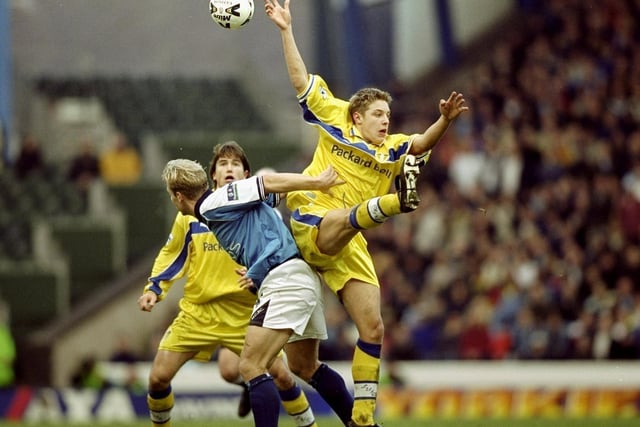 Alan Smith tussles with Manchester City's Gerard Wiekens.