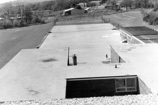 A view from the school roof facing west and showing Clayton Woods in the distance in 1973. The prefab building on the right is the Art Block.