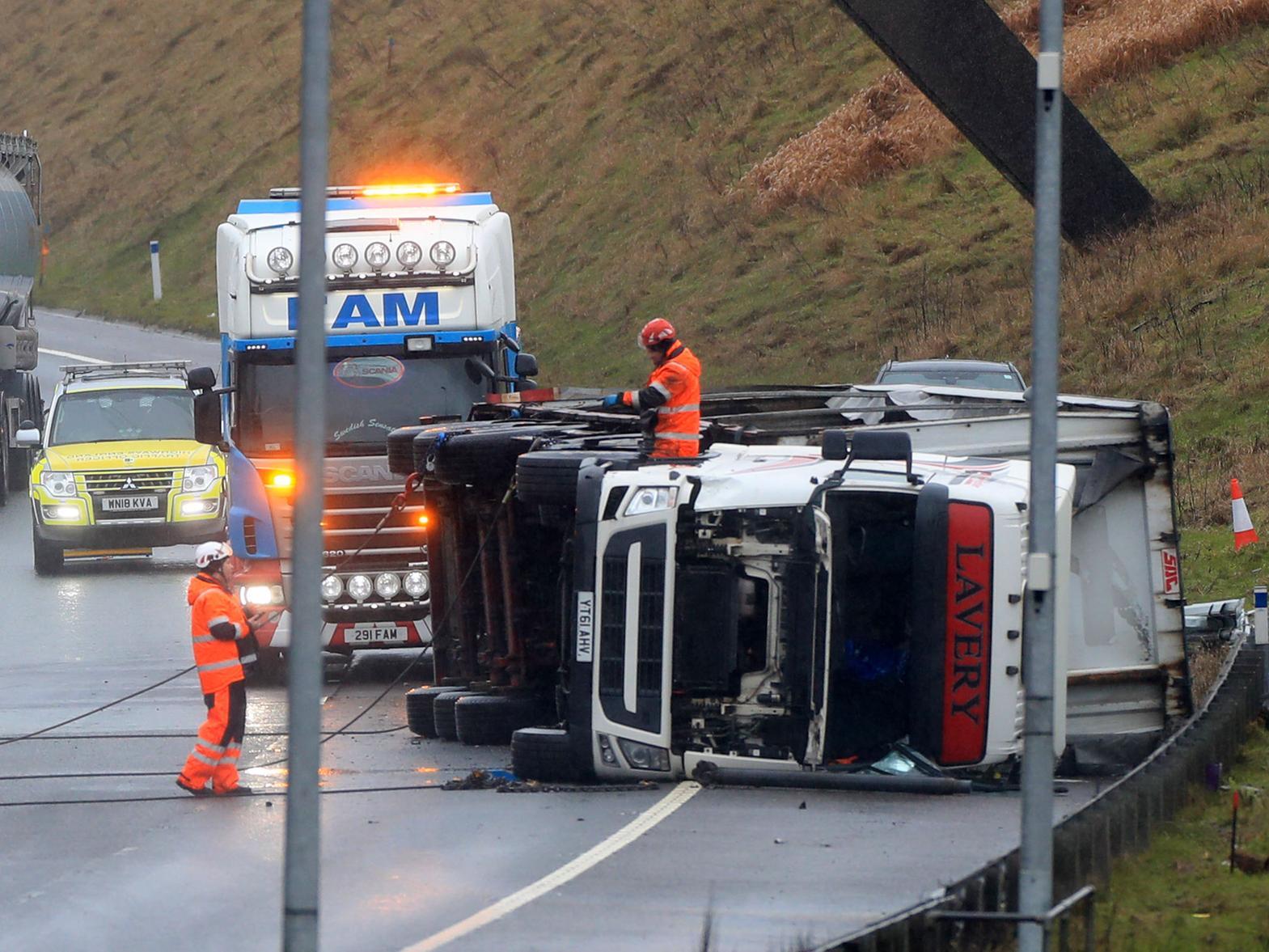Recovery agents are working at the scene of the accident (photo: PA Wire/ Danny Lawson)