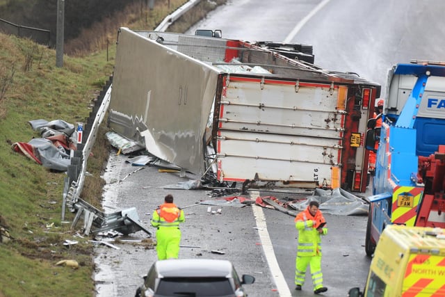 Specialist recovery workers prepare to recover the overturned lorry at the scene of the accident on the M62 (photo: PA Wire/ Danny Lawson)