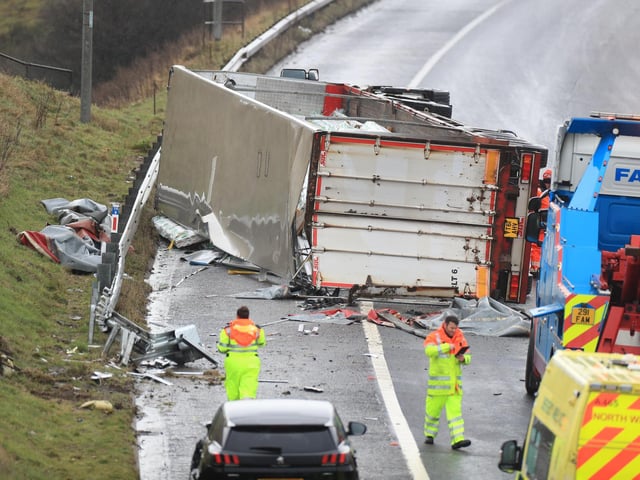 Specialist recovery workers prepare to recover the overturned lorry at the scene of the accident on the M62 (photo: PA Wire/ Danny Lawson)