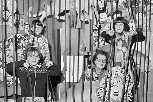January 1978 - Headmistress Miss Muriel Gardner with pupils Tony Fields, Dianne Wood and Tracy Morley in the lion's den, an artistic creation by the whole school at Marsh Green Junior School.