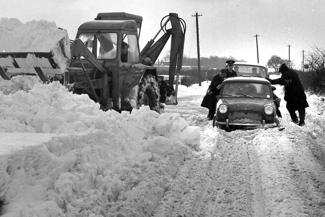 1968 - Snow Joke! A mini is halted by the deep snow as Wiganers brave the arctic snowfall of January 1968.