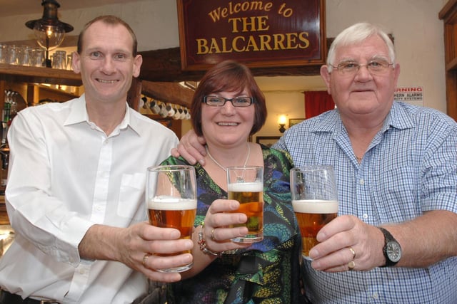 from left, Chris and Vicky Mayers, new landlord and landlady of The Balcarres Arms, Haigh, pictured with Vicky's dad and the pub's former landlord, Malcolm Horrocks, 2010.