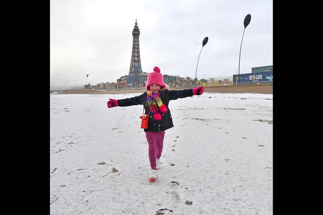 Daisy Bailey, six, from Blackpool, plays in the snow.