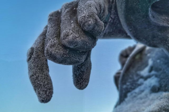 A close up of the frozen hand of Francis Sharp Powell statue by Phil Ormesher