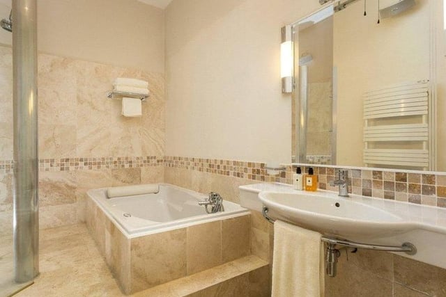 Three bathrooms are located throughout, including a house bathroom which is modern in style and features a bath, shower, heated towel rail and Travertine tiled floor.