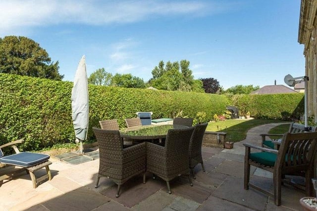 To the side of the property is an enclosed garden with a paved terrace area, which is ideal for al fresco dining, a spacious lawned area and external access to a wine cellar.