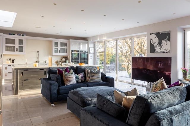 The comfortable living area has space for sofas and a dining table, while enjoying the porcelain tiled floor with under-floor heating and inset ceiling spotlights and speakers.