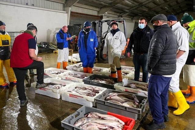 Market manager Alastair Ewen (third left) conducts an auction of fish brought in this morning at the docks in Fleetwood