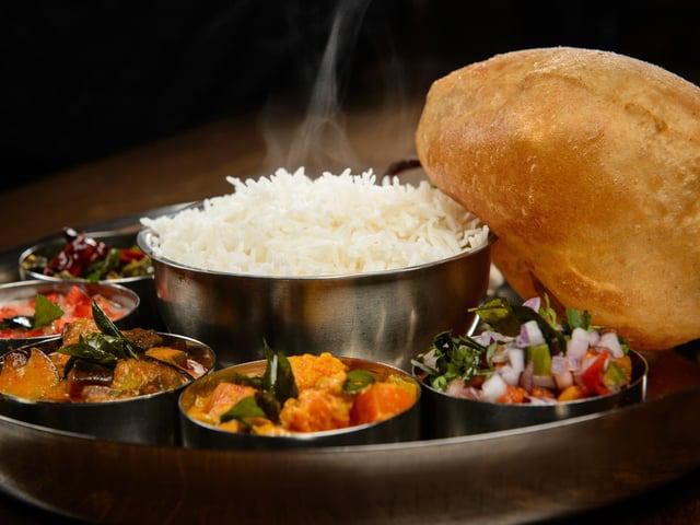 A Michelin Guide judge described Tharavadu, in Mill Hill, as: "A simple-looking restaurant with seascape murals. The extensive menu offers superbly spiced, colourful Keralan specialities and refined street food – the dosas are a hit. Service is friendly and dishes arrive swiftly."