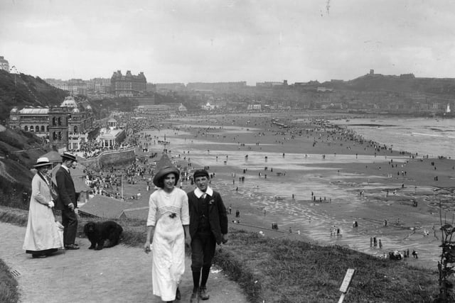 circa 1913: Couples enjoying a bit of sea air, walking along the cliffs at Scarborough.