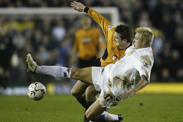 Alan Smith battles for the ball with Wolves defender Lee Naylor.