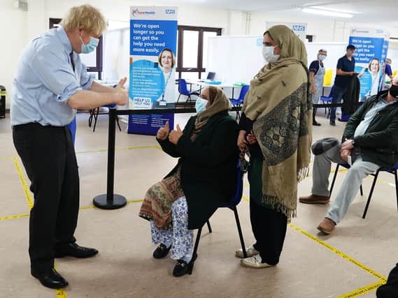 Prime Minister Boris Johnson shows thumbs up to patients after they were given the vaccine