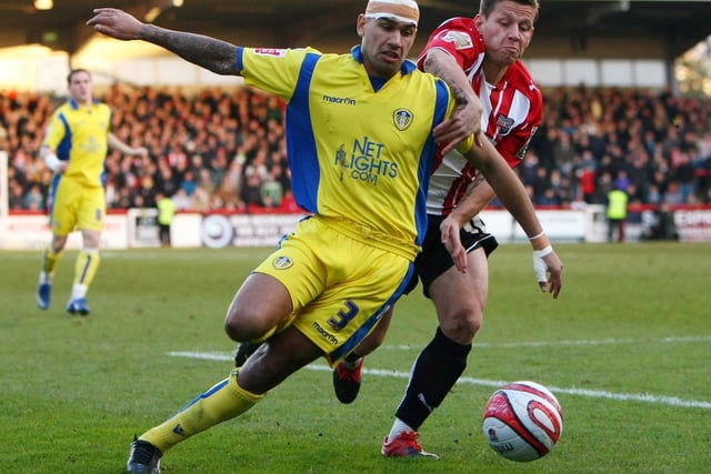 Patrick Kisnorbo is challenged by Brantford's Charlie MacDonald during the Coca-Cola League One clash at Griffin Park in December 2009.