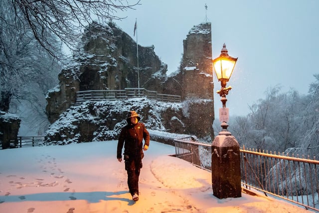 A man walks near Knaresborough Castle in Knaresborough, North Yorkshire, after snow fell overnight.