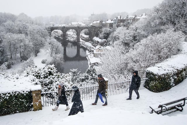 A snow covered Knaresborough in front of the River Nidd bridge.