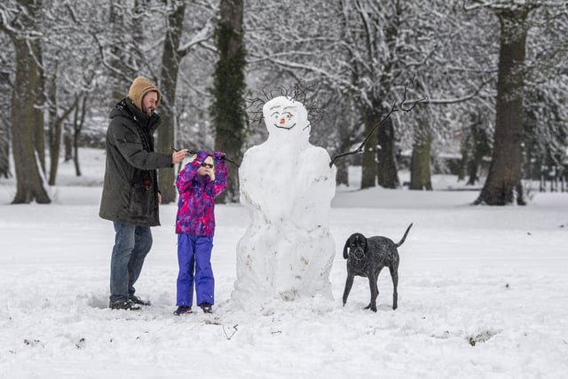 Noa Acaster Clarke with her dad Aidan building a snowman in Horsforth Hall Park.