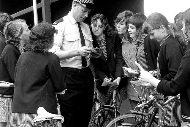 A Wigan traffic policeman instructs youngsters about cycling proficiency in 1971