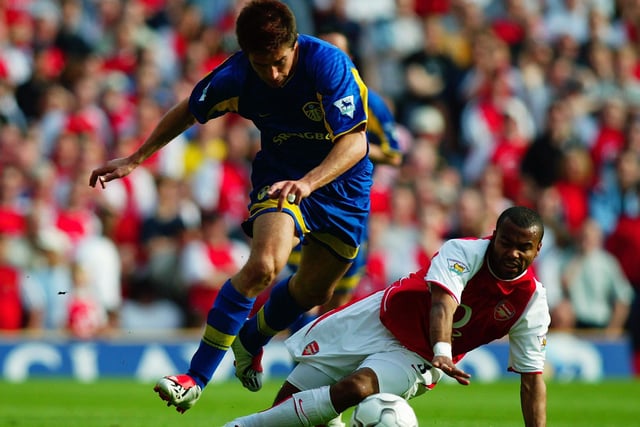 Harry Kewell skips past the challenge of Arsenal's Ashley Cole.