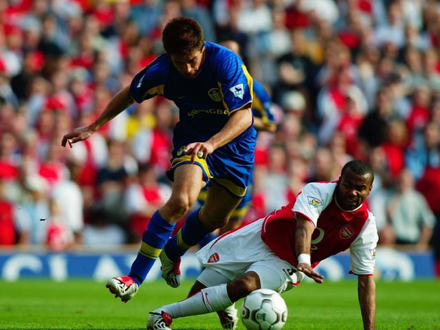 Harry Kewell skips past the challenge of Arsenal's Ashley Cole.
