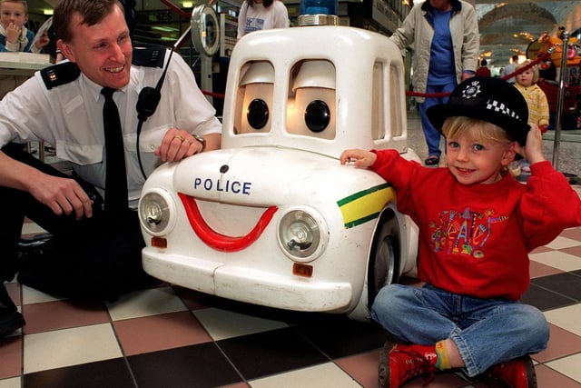 Local shops teamed up with Killingbeck Police to promote road safety at Crossgates Shopping Centre. Young Holly Walker meets Percy the Police Car with PC Lloyd Peatfield who was the driving force behind the event.