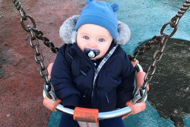 Laura Jane's little one was all dressed for adventure as he tried out the swings for the first time.