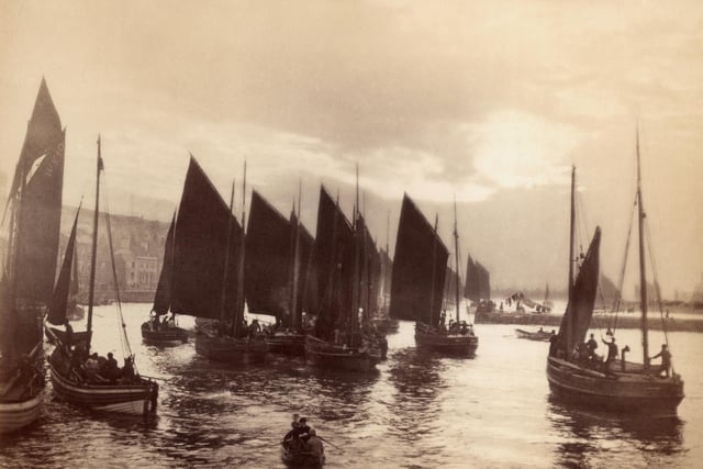 circa 1880: Small fishing boats about to set sail from Whitby harbour.